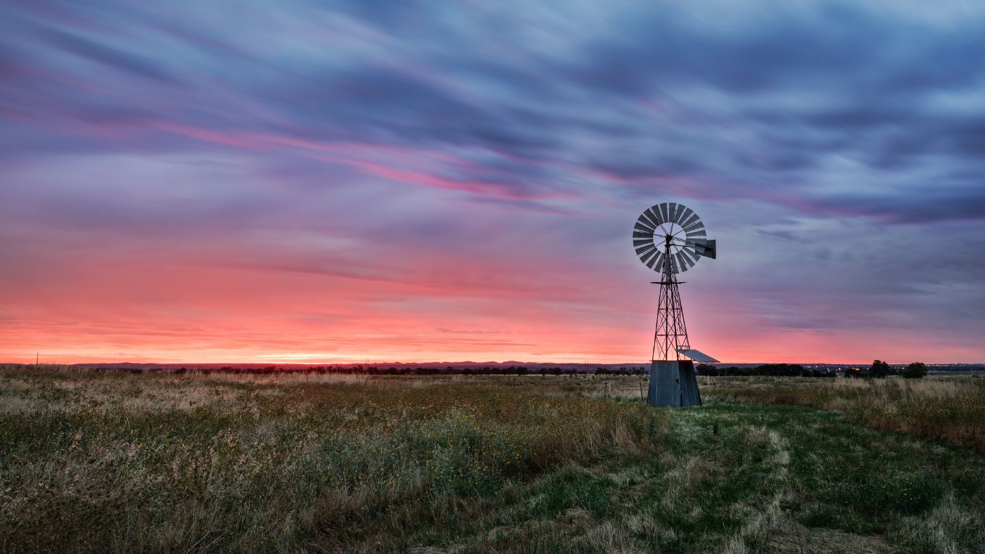 Photograph of a windmill set against a background of the sun setting in Dubbo NSW.