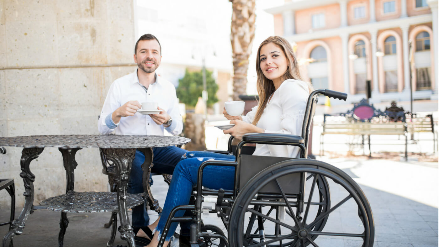 Woman in a wheelchair having coffee with a friend