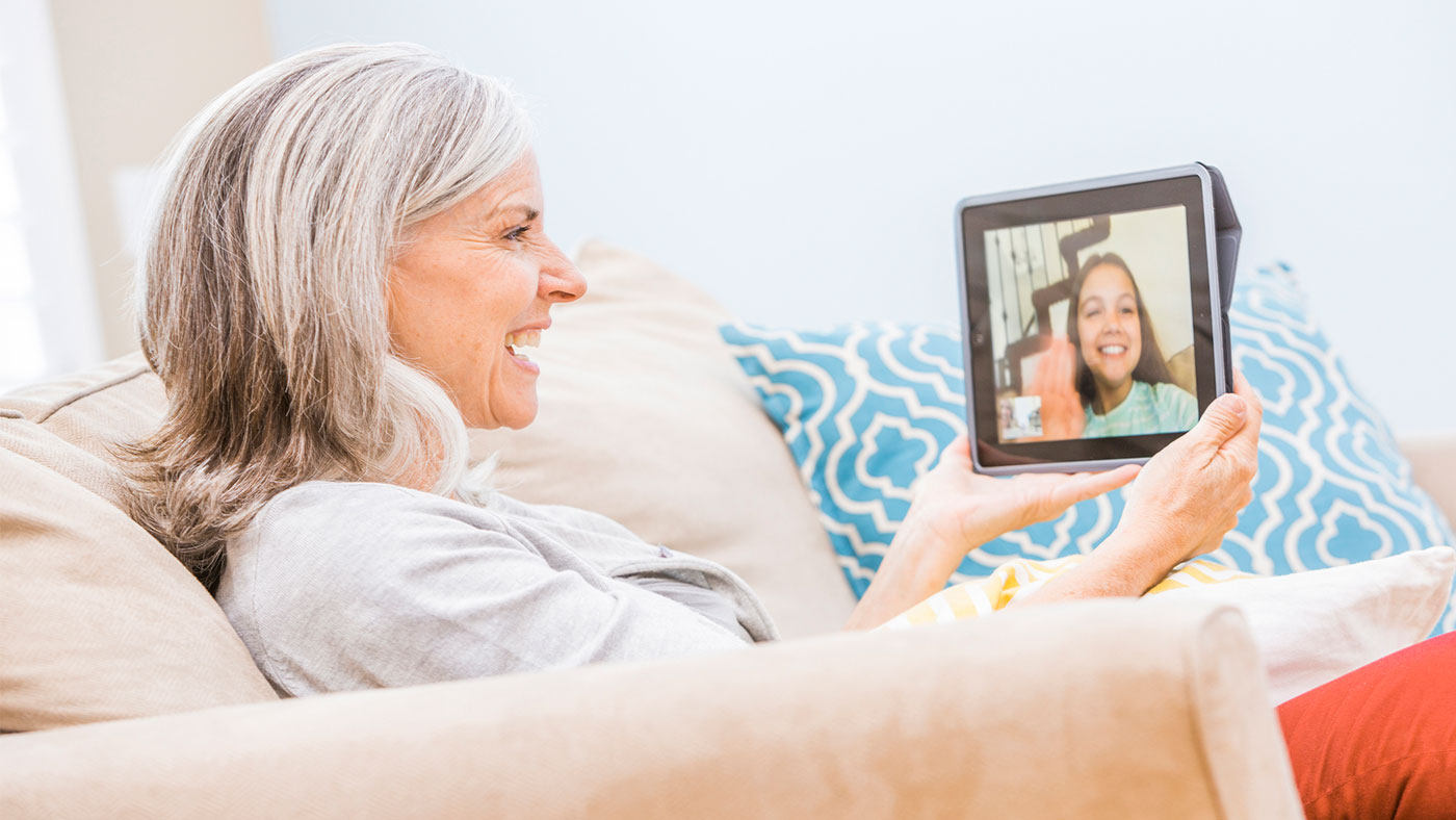 Caucasian-grandmother-videochatting-with-granddaughter-on-digital-tablet Caucasian grandmother videochatting with granddaughter on digital tablet.
