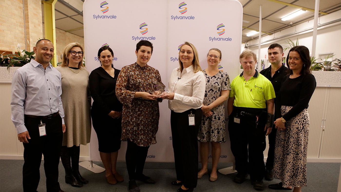 Sylanvale employees being presented with the icare award for September at the Sylanvale office