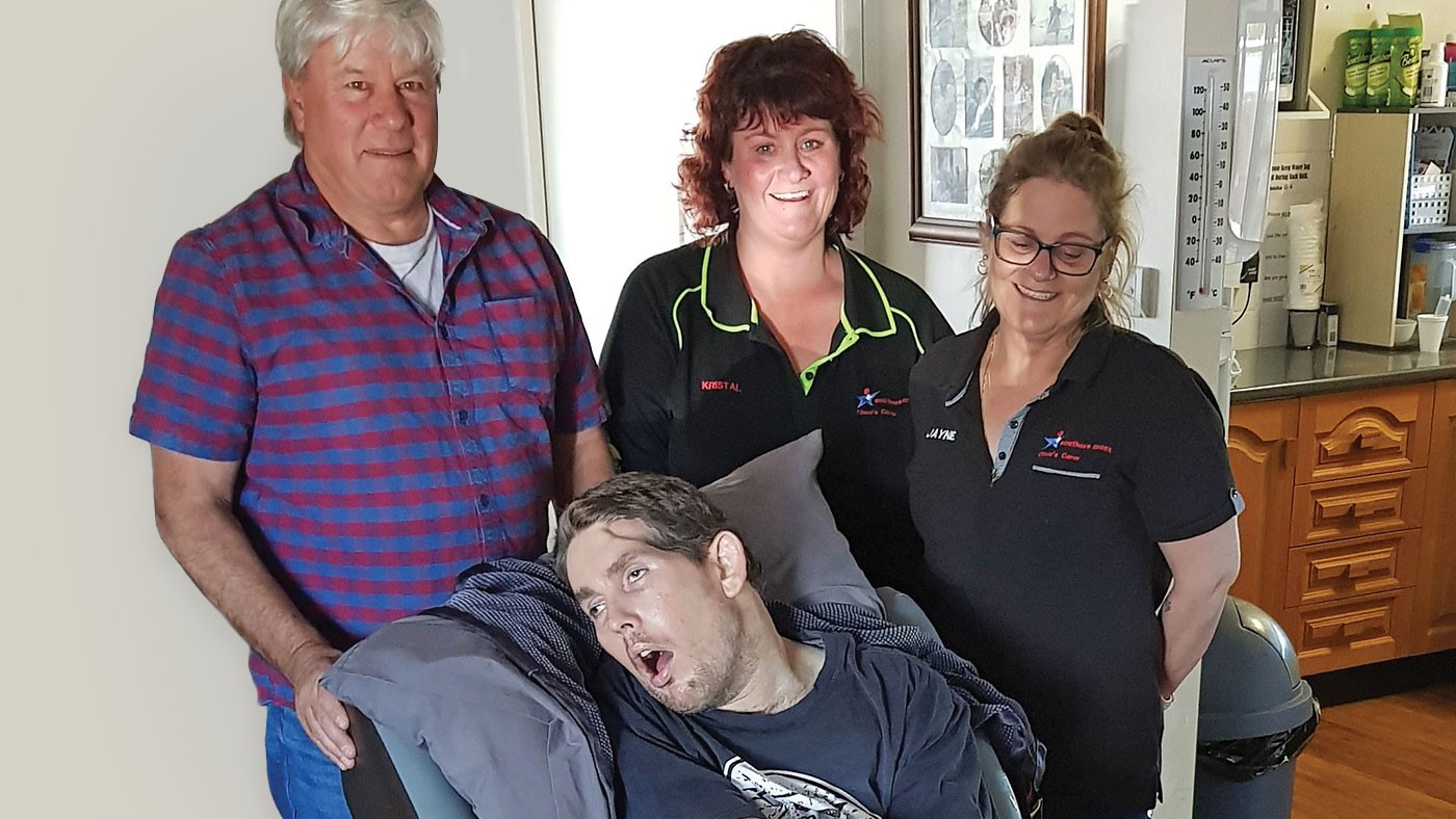 Two men and two women are smiling at the camera.