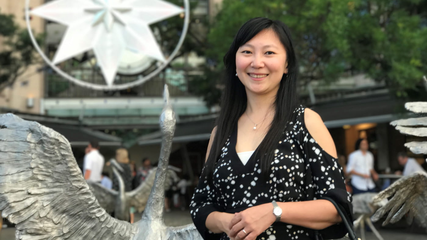 Ivy Wang stands in front of a sculpture