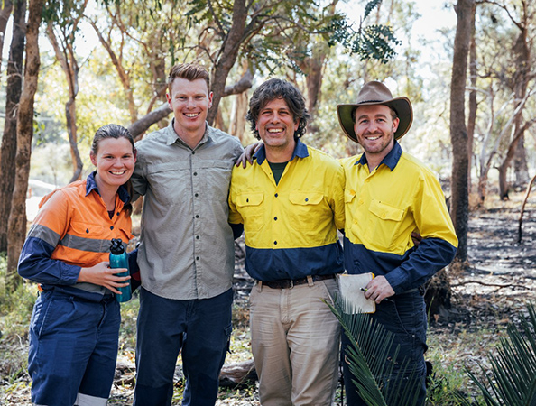 Four work health and safety professionals standing in a bush environment