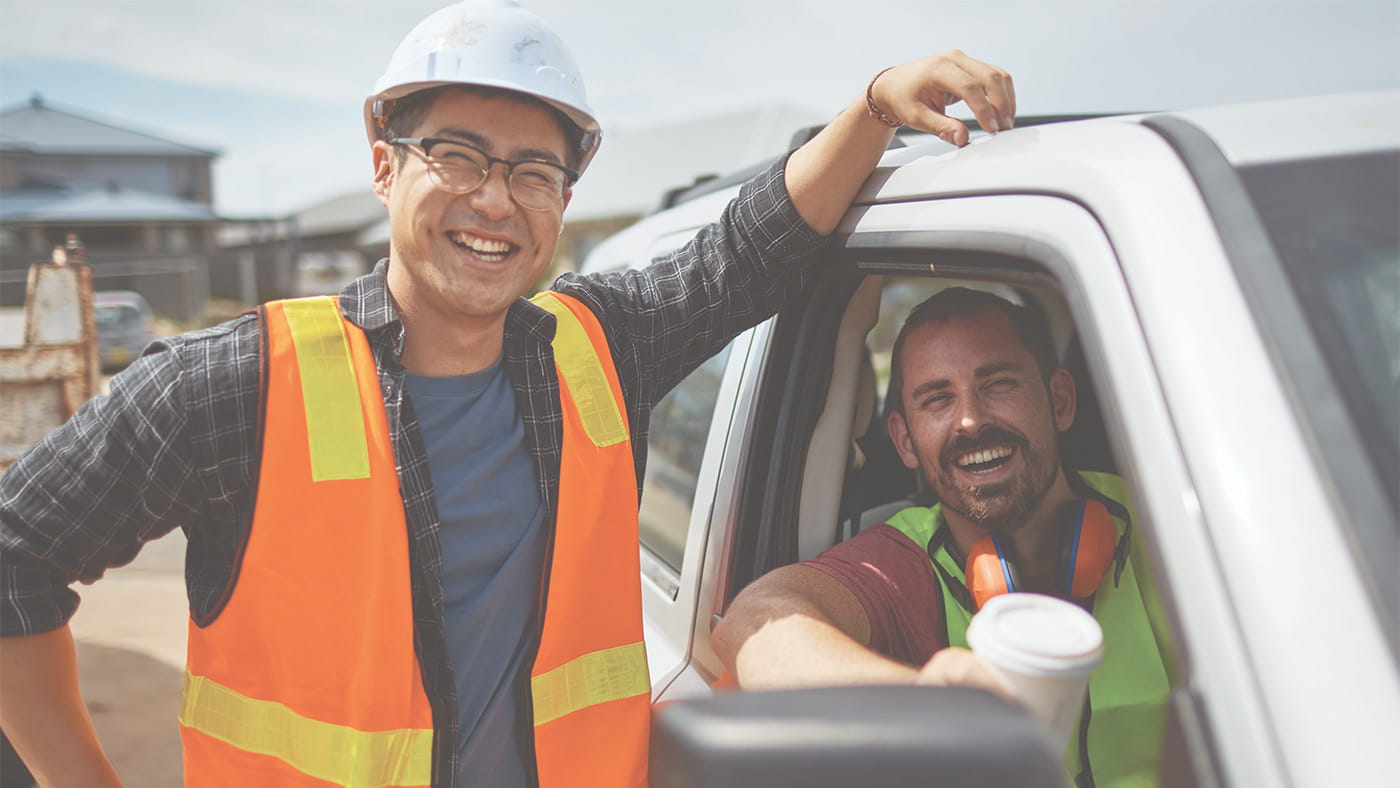 two construction workers smiling