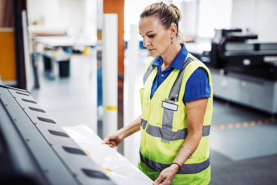 Female in hi vis at printer