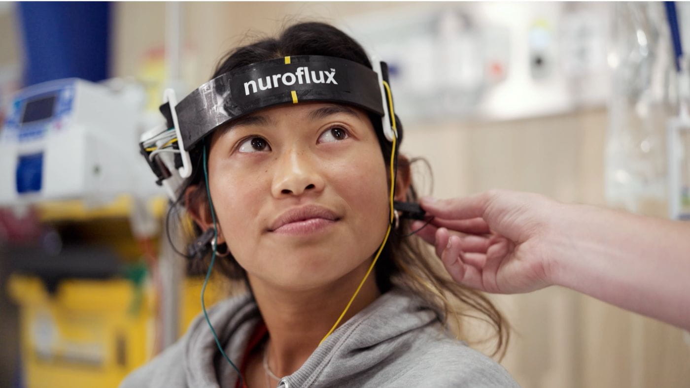 Girl using Nuroflux technology headset