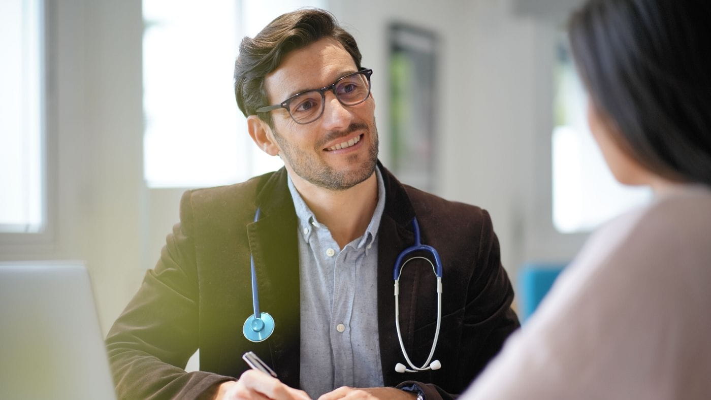 Male doctor consulting with a female patient